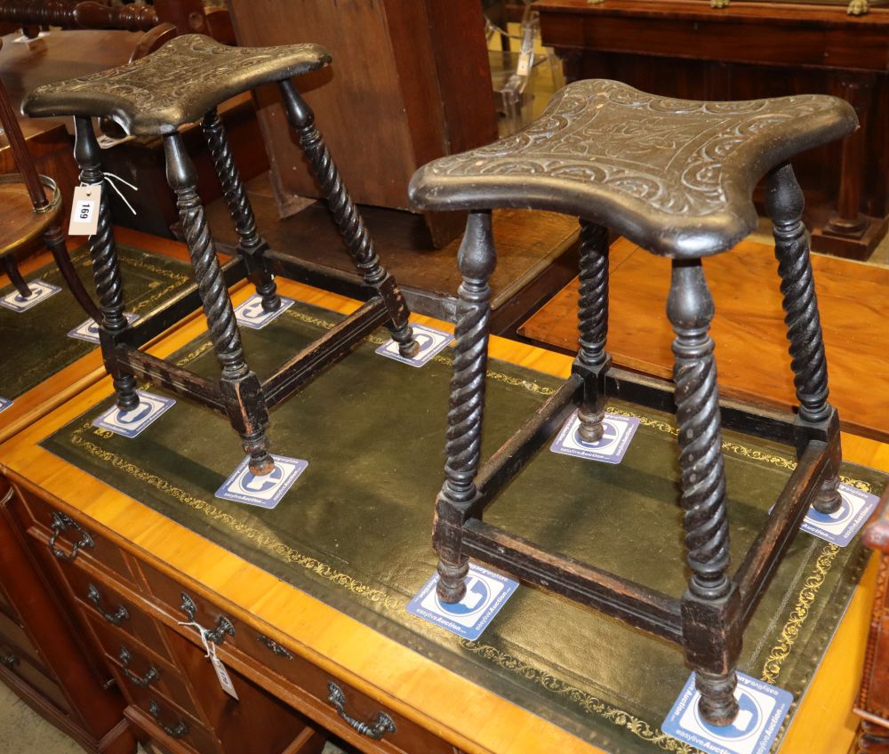 A pair of late Victorian carved oak stools, W.29cm, H.49cm
